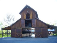 a large barn with two stalls on each side