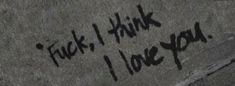 graffiti written on the side of a building that says,'f k i think i love you '