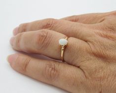 "14K Yellow Rosy Gold Opal Ring Size: 5.25 Stamped: \"14\" Oval Opal measures 5.27 X 4.47 X 2.25 mm - approximately 0.30 ct Ring head rise (from finger when worn): 6 mm Band width: 1.20 mm Condition: Good vintage condition, with light wear. No major flaws to note Opal is a hard gemstone too photograph. Please watch the video showing the play of colors. Total Weight: 1.3 g 0820-5015 RL-0414 FEEL FREE TO MESSAGE ME WITH A BEST OFFER OR IF YOU WISH TO SEE MORE PICTURES! * Back to Shop Watch and War Oval Opal Ring With Prong Setting For Gift, Oval Opal Ring With Prong Setting, Classic Oval Opal Ring With Prong Setting, Classic Oval Solitaire Opal Ring, Classic Oval Solitaire Moonstone Ring, Oval Moonstone Ring In Yellow Gold With Prong Setting, White Oval Moonstone Ring With Prong Setting, Oval Moonstone Ring With Prong Setting For Anniversary, Gold Opal Ring