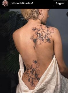 the back of a woman's body with flowers on her left shoulder and chest