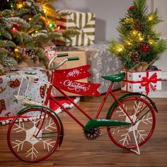 a red bicycle with christmas decorations on it