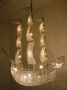 a chandelier made out of crystal beads and a ship shaped like a boat