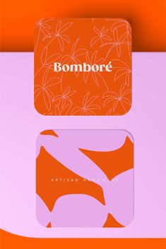 two coasters with the words bonmbore and an orange flower design on them