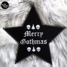 a black and white star ornament with merry christmas written on it