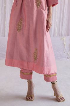 Gulab pink chanderi kurta with hand embroidered floral motifs. Paired with cotton silk cigarette pant.
Component: 2
Pattern: Embroidered
Type Of Work: Floral Motifs
Neckline: V-Neck
Sleeve Type: Three Quarter
Fabric: Kurta: Chanderi, Pant: Cotton Silk, Lining: Shantoon
Color: Pink
Other Details: 
Floral buttas
Lace trims
Side pockets
Note: The dupatta worn by the model is not for sale
Occasion: Puja - Aza Fashions Pink Kurta, Lace Trims, Fashion App, Floral Motifs, Pant Set, Set For Women, Cotton Silk, Aza Fashion, Floral Motif