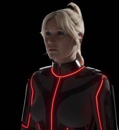 a woman in a futuristic suit with neon lights on her chest and shoulder, looking at the camera