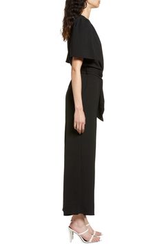 An updated alternative to classic officewear, this sleek jumpsuit features a flattering surplice neck and waist sash for an extra touch of elegance. 56" length Front button closure Surplice V-neck Short sleeves Removable tie belt Partially lined 100% polyester Hand wash, line dry Made in the USA of imported fabric Women's Clothing Sleek V-neck Jumpsuits And Rompers For Work, Elegant Belted Solid Jumpsuits And Rompers, Elegant Belted Pantsuit For Evening, Chic Workwear Jumpsuits And Rompers With Belted Cuffs, Chic Jumpsuits And Rompers With Belted Cuffs For Work, Solid Color Tie Waist Jumpsuits For Work, Sleek Formal Jumpsuits And Rompers, Chic Formal Pantsuit With Belted Cuffs, Evening Fitted Jumpsuits And Rompers With Tie Waist