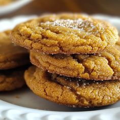 several cookies stacked on top of each other on a white plate with powdered sugar