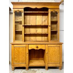 an old wooden china cabinet with glass doors