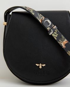 Our classic saddle bag has been given a seasonal update. The curved design evokes a sense of country life, reminiscent of a classic equestrian saddle bag but with a magical finish with the application of our A Night's Tale print to the strap. This compact cross-body, in midnight black certified vegan leather, is the perfect carrier to accompany you on your journey through your very own Night's Tale.
  Key features:
  Approx. 17 (L) x 18 (H) x 5 (D) cm
 Outer: 100% Vegan Leather; Lining: 100% Pol Equestrian Saddle, Swan Jewelry, Luxury Christmas Gifts, Twilly Scarf, Bottega Veneta Shoulder Bag, Louis Vuitton Shoulder Bag, Midnight Black, Saddle Bag, Perfect Bag