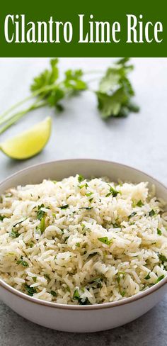 a white bowl filled with rice next to cilantro and limes on the side