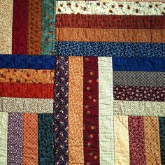 a close up of a colorful quilt with many different colors and designs on it's edges