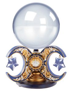 a glass ball on top of a stand with two stars and crescents around it