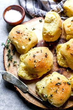 small rolls with herbs and garlic on a wooden plate