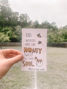 someone holding up a piece of paper that says kind words are like honey sweet to the soul