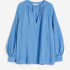 Loose-Fit Blouse In Double-Weave Cotton. Low Stand-Up Collar, V-Shaped Opening At Front, And Long, Raglan-Cut Balloon Sleeves With Button At Cuffs. H&m V-neck Tops For Daywear, Chic Blue H&m Tops, H&m Relaxed Fit Spring Blouse, Chic Blue Blouse From H&m, Blue H&m Top For Work, H&m Blue Workwear Top, Chic Blue H&m Blouse, Chic Blue Blouse By H&m, H&m V-neck Blouse For Summer