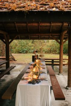 a long table is set up with candles