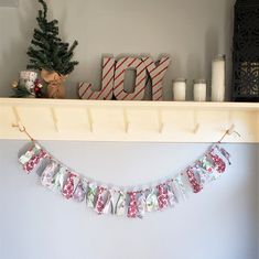 a christmas banner hanging from a mantle