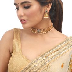 This antique choker set by Tarinika is designed for someone who likes simple Indian jewelry. The necklace is crafted with beautiful patterns and CZ stones on an antique gold-plated finish. It comes with traditional Jhumki style earrings which can be worn alone. Style this beautiful CZ antique choker set on your favorite ethnic outfit. Specification: Weight - 30 gm (necklace); 13 gm (earring); Length - 19cm (necklace); 4 cm (earring), 100% Satisfaction Guarantee: 1 Year Warranty, Long Lasting Pla Traditional Simple Necklace, Simple Choker Gold Indian, Simple Gold Necklace Indian, Gold Choker Necklace Indian Simple, Simple Choker Designs, Simple Gold Choker Necklace Designs, Antique Choker Designs, Choker Set Design, Choker Necklace Indian Gold