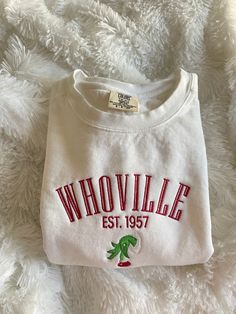 Get in the festive spirit with our Christmas Whoville Sweatshirt! Perfect for the holiday season. This sweatshirt is not only comfortable and cozy - it is made of a high quality preshrunk fleece to keep you warm throughout the winter months.  This sweatshirt is available in 6 colors:  🎄 White 🎄 Pepper Gray 🎄 Light Gray 🎄 Blue Spruce 🎄 Light Green (as seen in listing photo) 🎄 Crimson Red (words will be white) If there is a color you have in mind other than the ones listed, send me a message Cute Christmas Crewneck, Embroidery Machine Sweatshirt, Christmas Crew Neck Sweatshirt With Embroidered Logo, Casual Embroidered Christmas Top, Machine Embroidered Sweatshirt Ideas, Casual Christmas Tops With Embroidered Graphics, White Top With Embroidered Logo For Christmas, White Tops With Embroidered Logo For Christmas, Christmas Embroidery Gifts