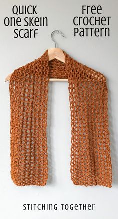 an orange crochet scarf hanging on a white wall with the words stitching together