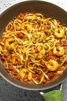 pasta with shrimp and tomato sauce in a pan