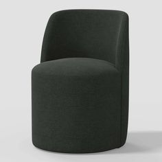 a dark green chair sitting on top of a white floor