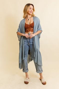 This bohemian-inspired kimono features a solid color palette and delicate ruffle edges, creating a timeless and effortlessly stylish look. Perfect for layering over any outfit, this kimono adds a touch of boho flair to your ensemble. Whether you're dressing up for a night out or looking for a stylish cover-up, our Solid Ruffle Edge Bohemian Kimono is the go-to choice for easy, breezy fashion. Our ethereal kimonos, offered in black, blue-gray, and ivory, embody effortless elegance. Each piece fea Bohemian Relaxed Fit Kimono For Daywear, Bohemian Spring Outerwear With Fringe, Flowy Wrap Kimono For Fall, Fall Flowy Wrap Kimono, Fall Rayon Open Front Kimono, Bohemian Long Duster For Spring, Bohemian Long Outerwear For Daywear, Fall Season Open Front Rayon Kimono, Summer Bohemian Outerwear With Frayed Hem