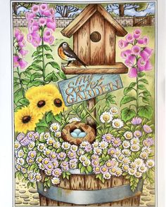 a birdhouse with flowers and birds in it