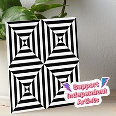 a black and white pattern with the words support independent artists on it next to a potted plant