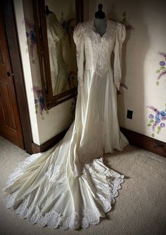 a wedding dress on display in front of a mirror