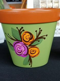 a flower pot with flowers painted on it