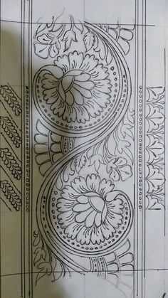 an intricately designed piece of paper on top of a sheet of paper with writing