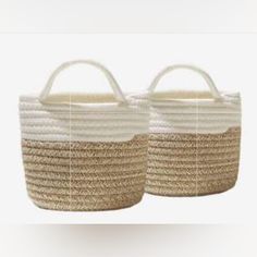 two woven baskets with handles on each side, one is white and the other is beige