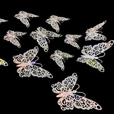 a group of white butterflies on a black background