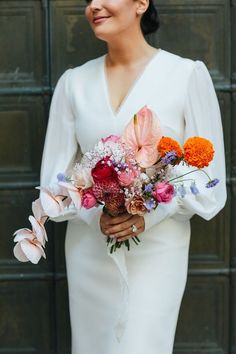 a woman in a white dress holding a bouquet of flowers