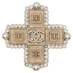 Chanel 2000s CC rhinestone-embellished cross brooch featuring gold-plated hardware, a cross motif, a signature interlocking CC logo, rhinestone embellishment, faux-pearl embellishment, a pin fastening, a back plaque. Circa 2000s . Made in France Length: 1.96in. (5cm) Width: 1.96in. (5cm) Excellent vintage condition. Made in France. We guarantee you will receive this gorgeous item as described and showed on photos. Chanel 2000s, Sophie's Choice, Cross Brooch, Pearl Embellishment, Shopping Chanel, Gold Brooches, Purse Styles, A Cross, Cc Logo