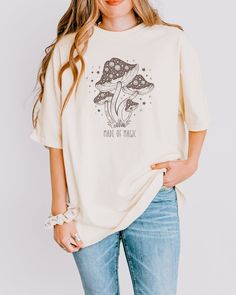 Designed for mushroom lovers, these Made of Magic tees are printed on Comfort Color tees that have been garment-dyed for a lived-in, vintage look. Please check the size charts for the perfect fit! ⭐Good to Know: Made using 100% US cotton that is ethically grown and harvested. Gildan is also a proud member of the US Cotton Trust Protocol, ensuring ethical and sustainable means of production. ⭐Details: ✨Oeko-Tex eco-friendly, non-toxic dyes ✨100% combed and ring-spun cotton ✨Pre-shrunk fabric ✨Des Summer Cotton Tops With Mushroom Design, Relaxed Fit Short Sleeve Tops With Mushroom Design, Cotton Crew Neck Tops With Mushroom Print, Cotton Short Sleeve Tops With Mushroom Design, White Short Sleeve Tops With Mushroom Design, White Short Sleeve Tops With Mushroom Print, White Short Sleeve Top With Mushroom Print, White Cotton Tops With Mushroom Print, Cute Short Sleeve Top With Mushroom Print