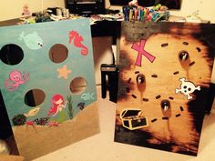 two cardboard boards decorated with sea creatures and pirate symbols are shown in front of a computer desk