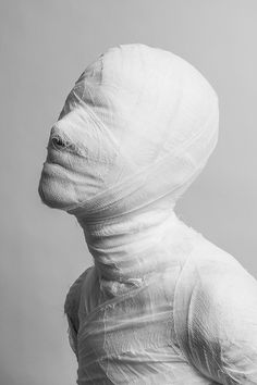 a person wrapped in white cloth and looking up