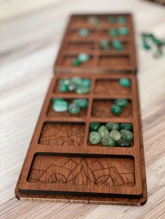 a close up of a wooden board game with beads on the top and one in the middle