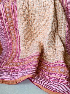 an orange and pink blanket on top of a table