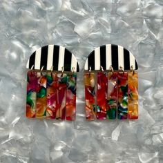 These earrings are all about movement! Features a unique half moon stud in a striking black and white stripe acrylic with a contrasting flirty fringe detail in a hand-swirled acrylic mix of all the colors in the rainbow; red, orange, yellow, green, blue, white and pink.  Designed for Closet Rehab. Handmade in Pittsburgh, PA. Made in the USA. Materials: acrylic, brass base posts/jump rings with 18k gold plating Hypoallergenic  Our accessories are handcrafted from colorful acrylic. To preserve your Closet Rehab products, we recommend storing safely in our pouches. Avoid contact with harsh substances like perfumes and hairsprays. Items with plated metals naturally tarnish over time when exposed to body oils and other natural elements. Please handle with care, as excessive dropping, wear and t September Birthstone Jewelry, Walk The Line, Moon Studs, August Birthstone Jewelry, July Birthstone Jewelry, Mini Hoop Earrings, Zodiac Gifts, Red Orange Yellow, Acrylic Jewellery