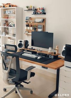 a desk with a computer and speakers on it