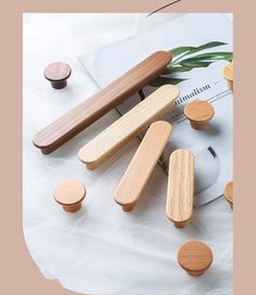 several wooden knobs on top of a white cloth covered table next to a pair of scissors