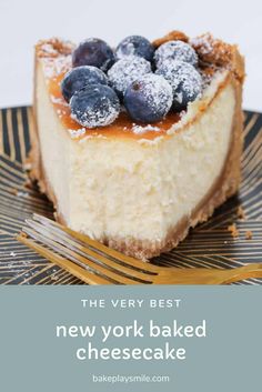 the very best new york baked cheesecake with blueberries and powdered sugar on top