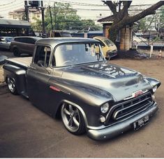 an old pickup truck parked in a parking lot