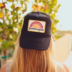 Sunshine State Rainbow patch on our all black unisex trucker. Foam front panel with custom patch. Mesh back panels Adjustable Snap Back Curved Brim One size Part of the proceeds from the sale of this hat go to organizations that protect Florida’s wildlife. Black Snapback Trucker Hat With Logo Patch, Adjustable Black Hats With Patches, Black Adjustable Hat With Patches, Adjustable Black Hat With Patches, Trucker Hat With Embroidered Patch For Streetwear, Black Trucker Hat With Logo Patch, Black Baseball Cap With Patches, Black Snapback Trucker Hat With Patches, Black Trucker Hat With Curved Bill And Logo Patch