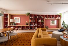 a living room filled with furniture and lots of bookshelves on top of it