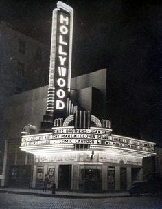 the hollywood theatre marquee is lit up in black and white for an old photo